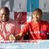 Rohto Mentholatum Sales and Marketing manager, John Macharia (right), signs a sponsorship cheque 