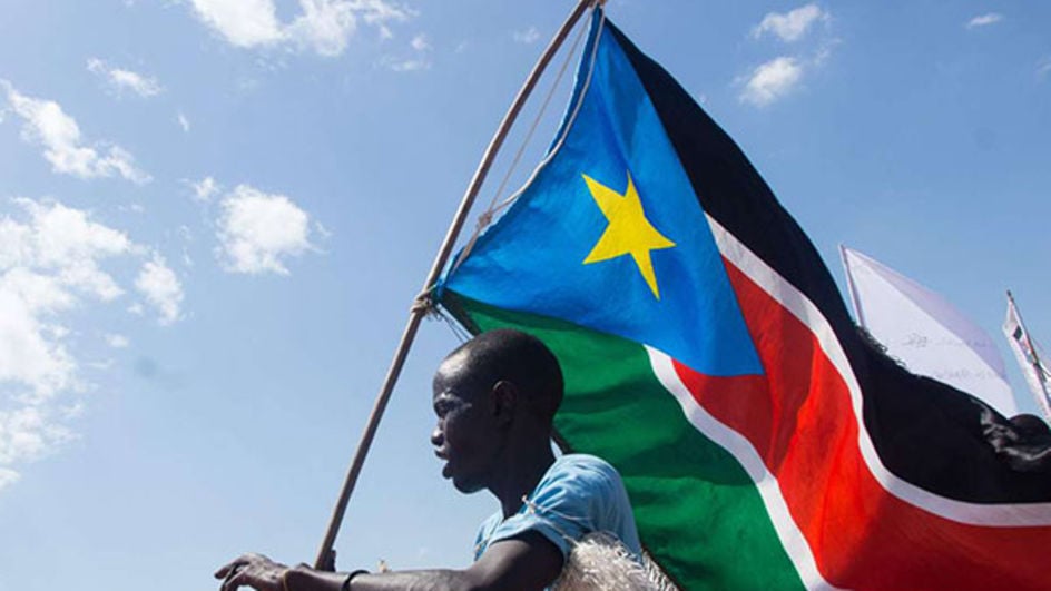 A man carries the South Sudan flag at Magateen Internal Displaced Persons centre in Juba on November 17, 2018. PHOTO | AKUOT CHOL | AFP
