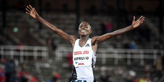 Rhonex Kipruto of Kenya reacts after crossing the finish line 
