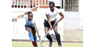 Kenyatta University's Gloria Juma (left) vies for the ball with Blazers' Rachel Ousa