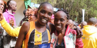 Caroline Gitonga (right) congratulates her twin sister Purity 