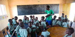 A teacher with his pupils in Turkana County.