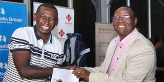 Nation Classic Golf series overall winner Adam Nyaga (left) receives his prize from NMG Board Chairman Wilfred Kiboro 